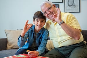 grandfather and grandson doing jigsaw puzzle together 