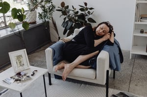 older woman fallen asleep on armchair during the day