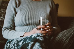 woman at home drinking glass of water