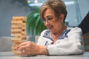 older woman playing Jenga