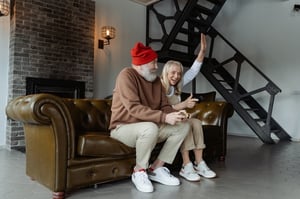 older couple playing videogames together indoors