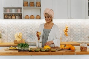 woman drinking water with citris juice in kitchen