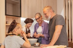 grandparents and grandchildren cooking together in kitchen