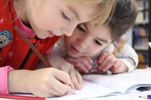 two young children drawing together