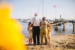 grandparents with grandchildren by the ocean