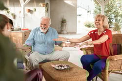 grandparents spending time with older grandchildren at home