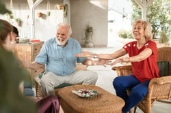 grandparents spending time with older grandchildren at home