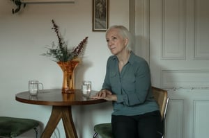 woman sitting at chair drinking water