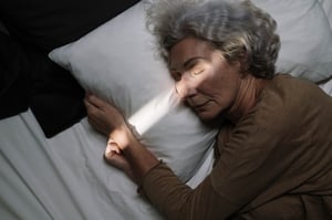 Older woman sleeping in bed