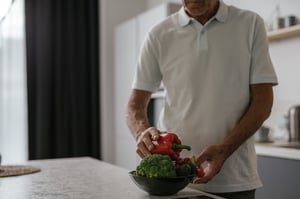 older man prepaing vegetables