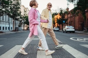 older couple walking together in street