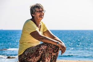 senior woman spending time alone at the beach