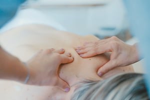 older woman receiving massage on upper back