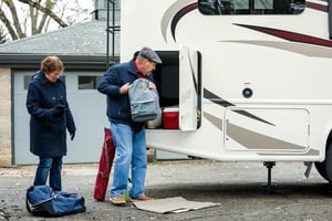 older couple taking bags out of RV storage