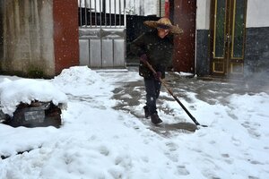 winter shoveling snow on sidewalk