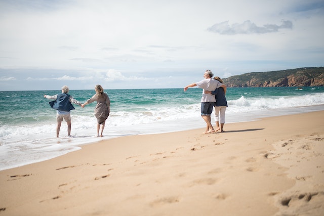 two couples enjoying time at the beach on vacation